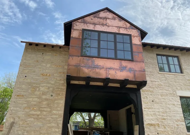 Copper metal panel facade on a stone building for Skylight Installation in Stuart